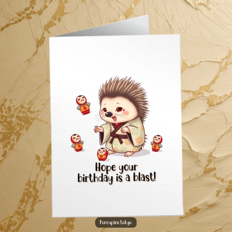 Funny Free Printable Birthday Card: Porcupine in patterned kimono playfully juggling daruma dolls, humorous downloadable birthday greeting.